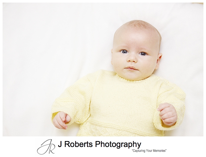 Baby in hand made yellow knitted jumper - sydney baby portrait photographer